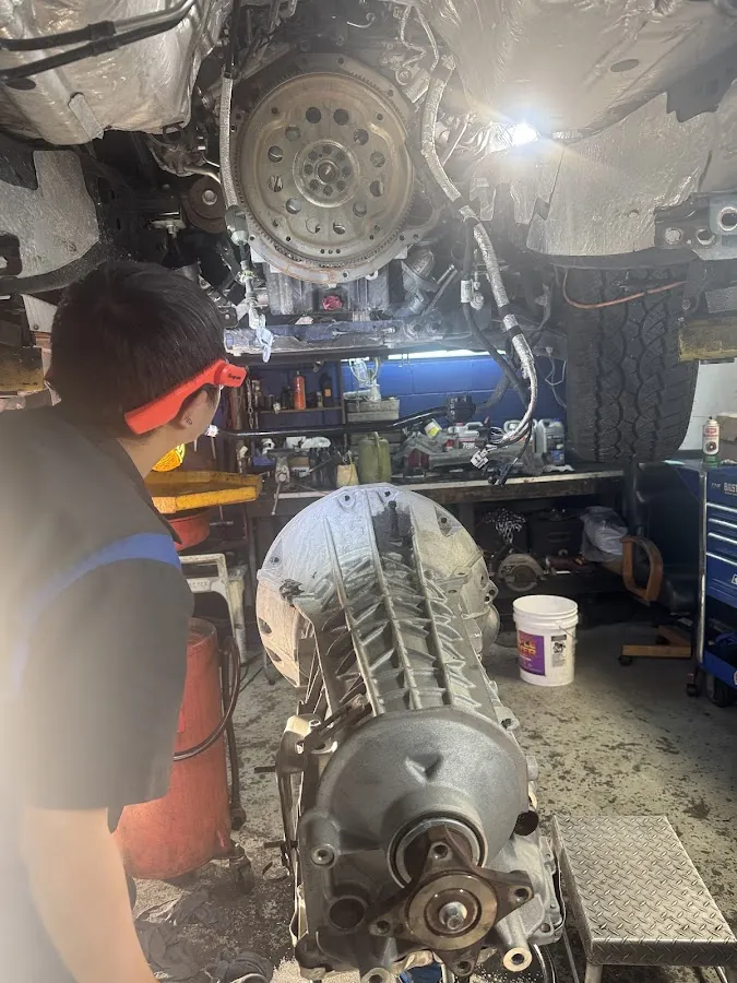 RepairTech technician installing transmission on vehicle lift in Kissimmee FL