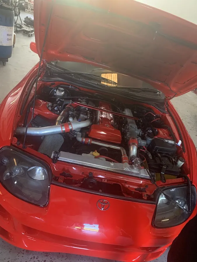 Red Toyota Supra 2JZ turbo engine bay at RepairTech Automotive performance service