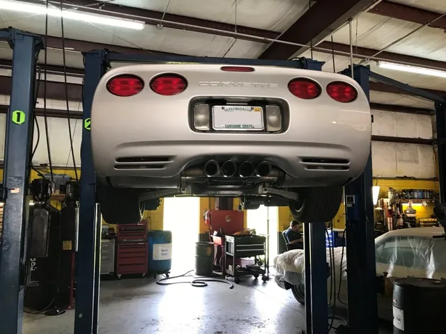 Corvette on hydraulic lift for brake inspection at RepairTech Automotive in Kissimmee FL
