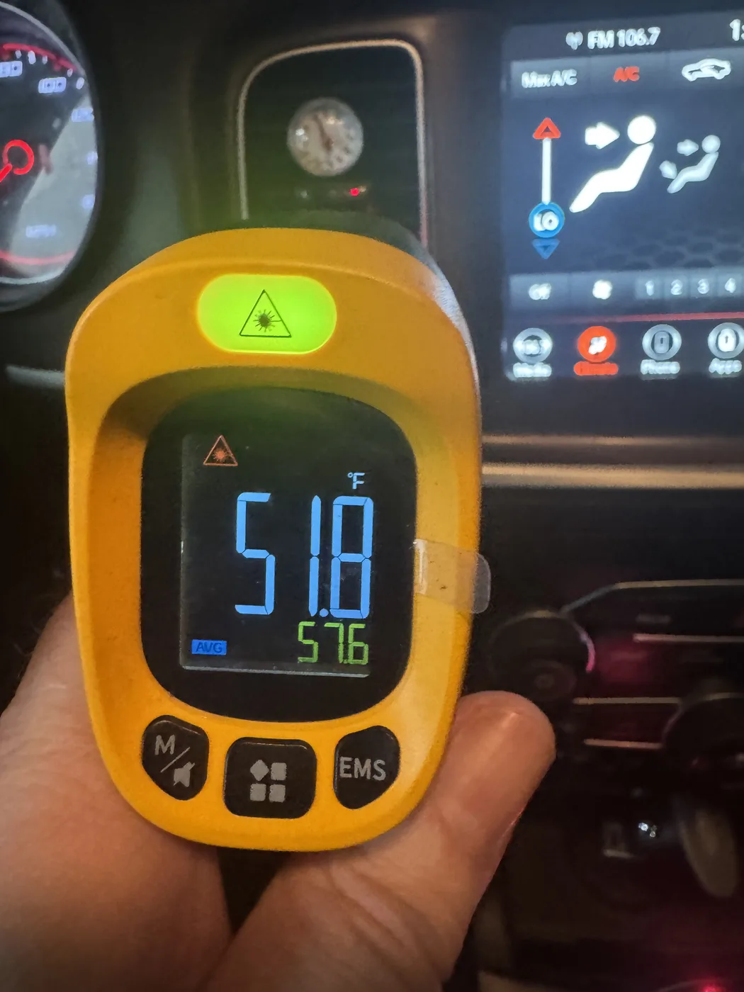 Infrared thermometer reading 51.8 degrees Fahrenheit at a vehicle's dashboard vent after A/C service at RepairTech Automotive in Kissimmee, with the climate control set to Max A/C